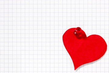 Paper heart pinned to the  paper sheet