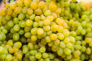 Fresh green grapes pile on the local market.  Crop Background
