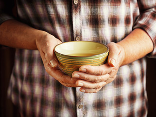Hands of senior woman holding cup of tea