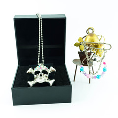 Ring of skull jewelry in jewelry box on white background