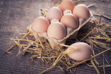 Chicken eggs on wooden background