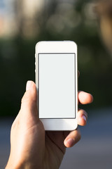 Person using mobile smart phone in the park.