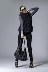 full length model girl in fashion dress with bag  posing