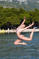 Fototapeta premium Girl jumping in the sea