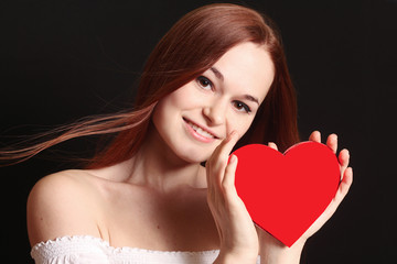 Valentines Day. Redhead woman holding Valentines heart