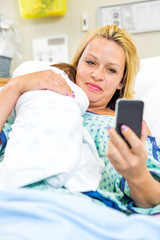 Woman Taking Self Portrait With Babygirl Through Smart Phone