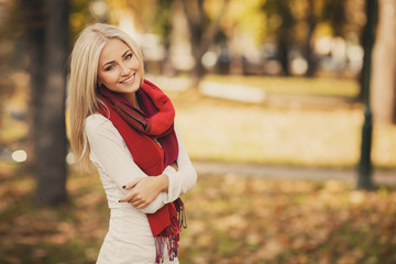 Portrait of very beautiful young woman in autumn park