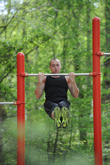 Young man training sport on horizontal bar