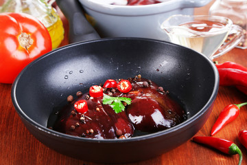 Raw liver in pan on cooking surface close-up
