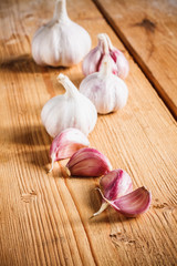 Raw garlic on wooden background