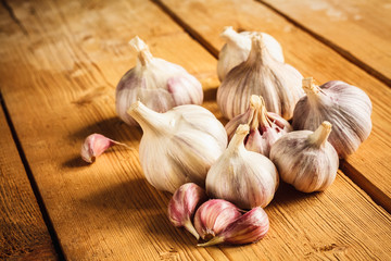 Raw garlic on wooden background