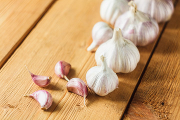 Raw garlic on wooden background