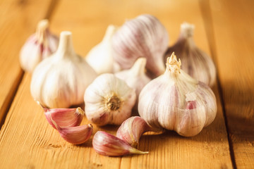 Raw garlic on wooden background