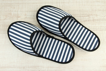 Striped slippers on wooden background