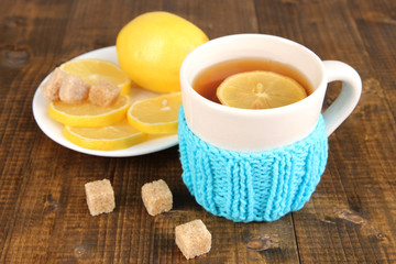 Cup of tea with lemon on wooden table