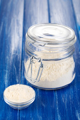 Starch in bowl and bank on wooden table close-up