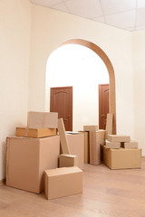 Empty room with stack of cartons: moving house concept