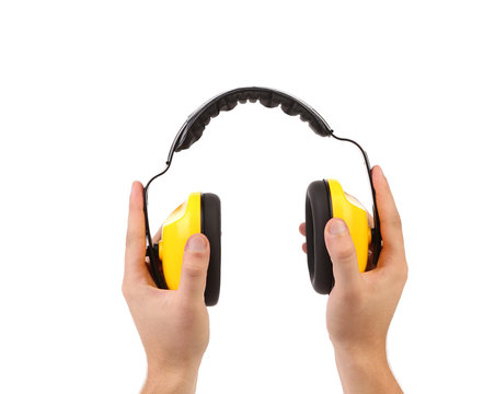Hands holds working protective headphones.
