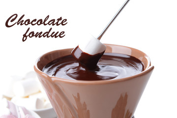 Chocolate fondue with marshmallow candies, isolated on white