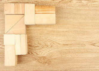 Wooden toy blocks on wooden background