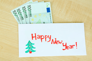 Euro banknotes in envelope as gift at New year