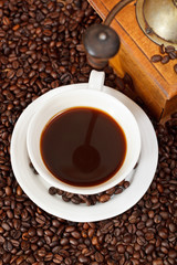 cup of coffee and roasted beans