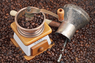 retro manual coffee mill on roasted beans