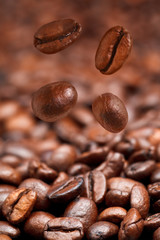 four falling coffee beans and roasted coffee