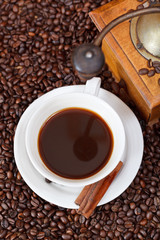 cup of coffee and roasted beans