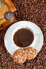 cup of coffee and roasted beans