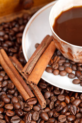 cup of coffee and roasted beans