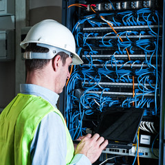 Electrician checking a fuse box