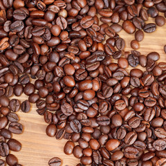 roasted coffee beans close up on wooden board