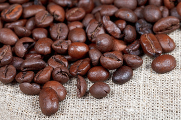 many roasted coffee beans on sacking