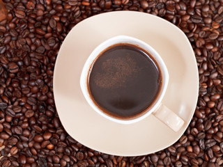 cup of coffee and roasted beans