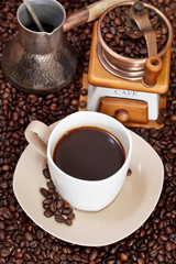 cup of coffee and roasted beans