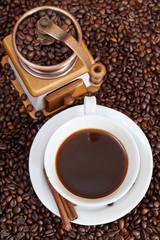 cup of coffee and roasted beans