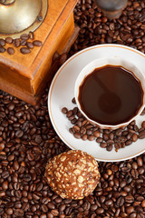 cup of coffee and roasted beans