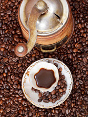 cup of coffee and roasted beans