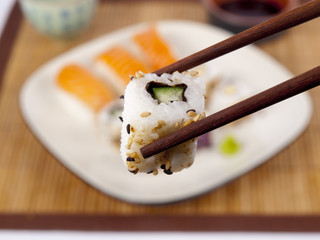 Fresh sushi and sashimi on a plate with chopsticks