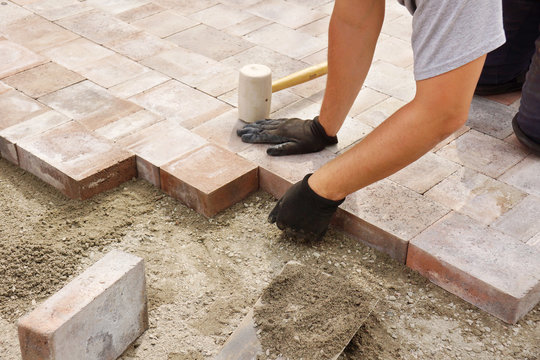 Worker installing paver