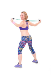 Young sporty woman exercising with a resistance rope