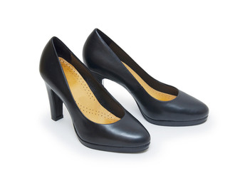 Close-up of female high-heeled shoes over white background