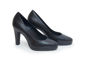 Close-up of female high-heeled shoes over white background