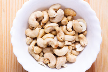 Plate with tasty nuts on the table