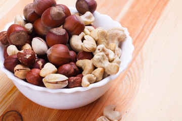 Plate with tasty nuts on the table