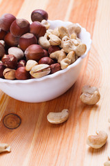 Plate with tasty nuts on the table
