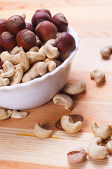 Plate with tasty nuts on the table