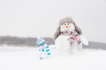 Happy winter snowmen family or friends (copy space)