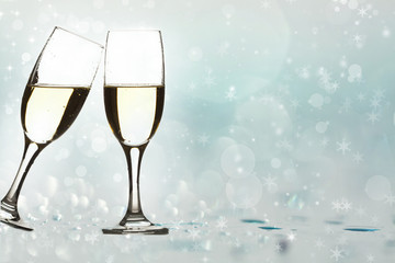 Glasses with champagne against holiday lights